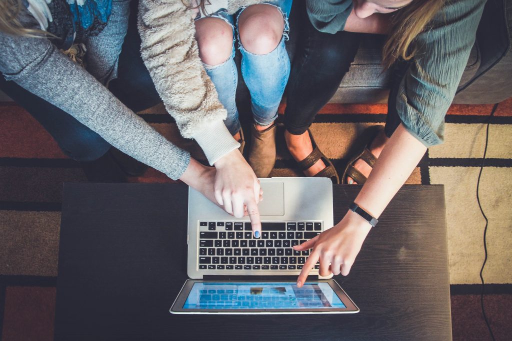 people pointing to a computer